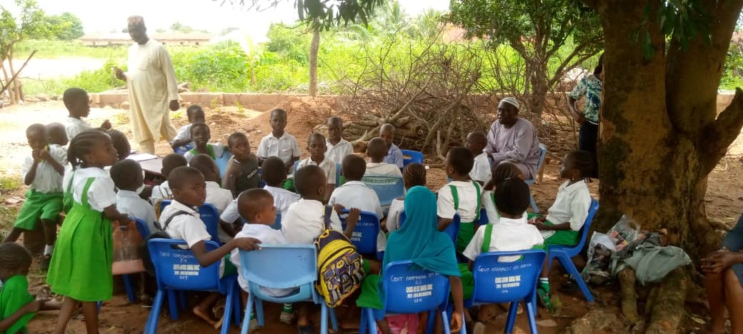 Pupils Receive Lesson Under Shades As Classroom Block Partially Collapsed In Obudu